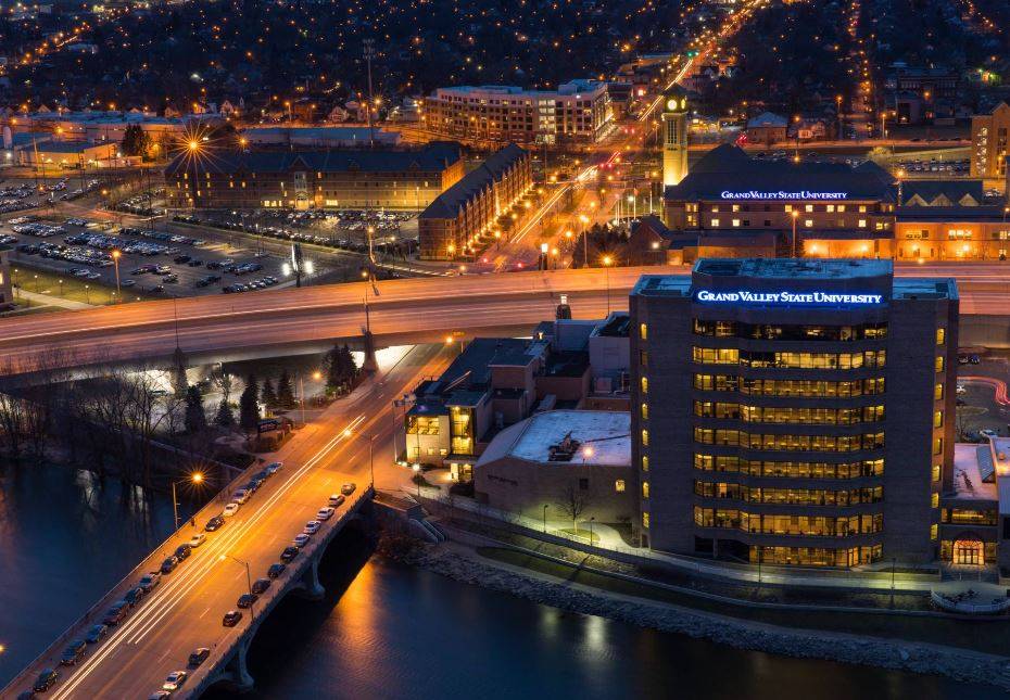 Grand Valley building downtown at night with highway